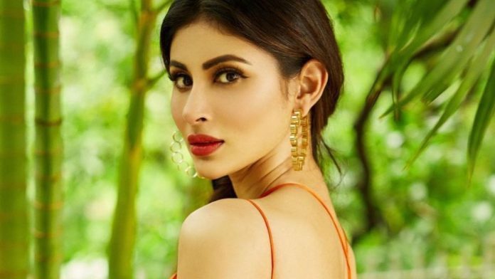 Mouni Roy wore a stylish bralette top with a lehenga, showed bo*ld looks lying on the table