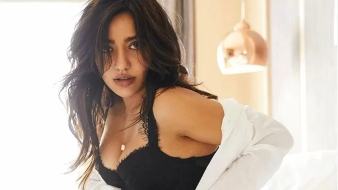 Neha Sharma opened all the buttons of the shirt to show boldness, flaunted bralette look